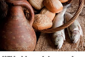 Old blessing  Religious still life of 5 loaves of bread, an antique wine jug and 2 fish : bread, loaves, fish, five, two, religion, jesus, miracle, christ, christianity, food, multiplication, galilee, tabgha, holy, communion, loaf, galilee, catch, wine, jar, pitcher, jug, ancient, medieval, antique, still life, blessing, fishing net, fish net, basket, vintage, old